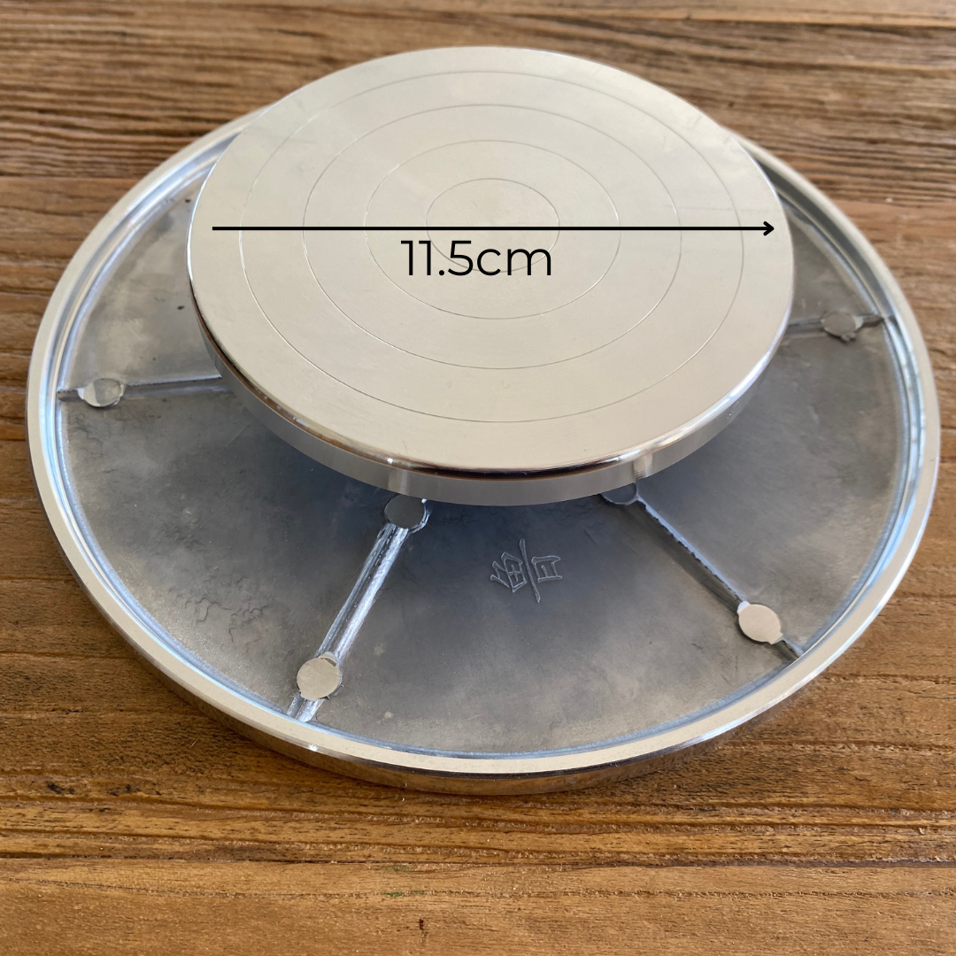 A double-faced aluminum pottery banding wheel, 11.5cm diameter