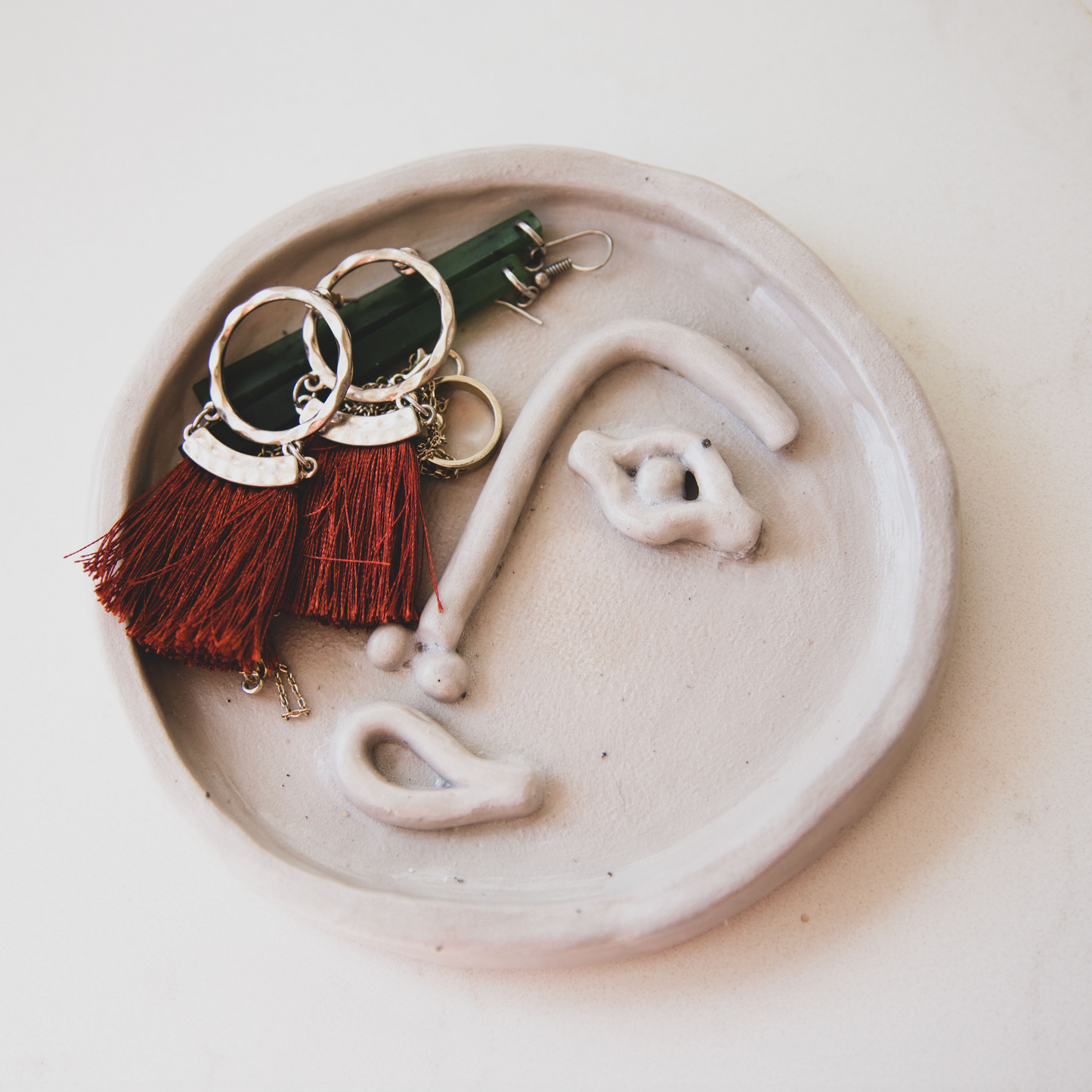 Face trinket dish made from air dry clay and sealed with clay play sealant.