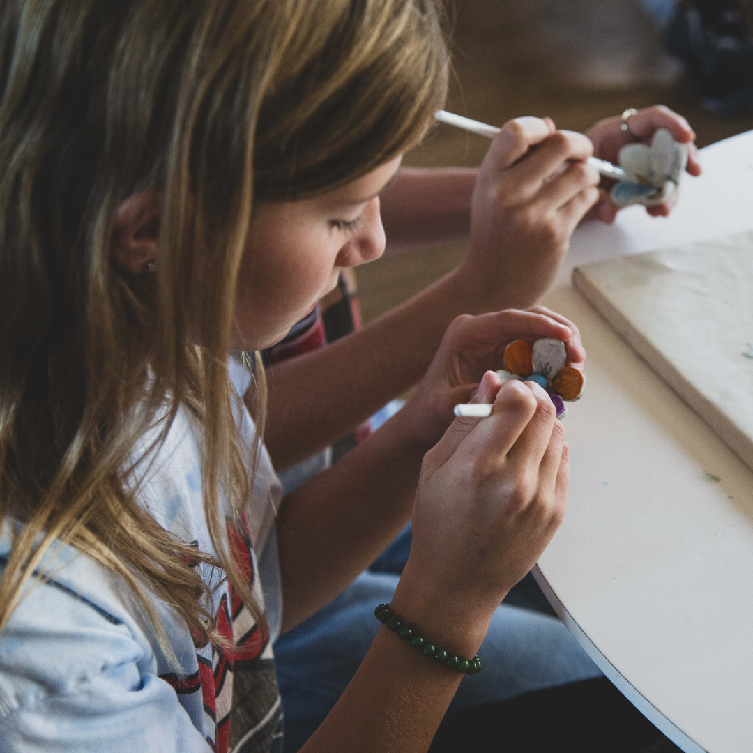 A teenage girl Painting colourful flowers made from A clay play Kids Air dry clay kit